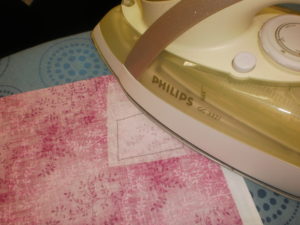 Using a hot dry iron (no steam) press the rough side of the Vliesofix to the wrong side of your chosen fabrics (one letter per fabric).