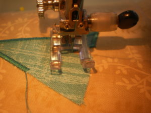 When stitching an internal point – stitch all the way along the edge prior to the point, leave the needle down on the right, lift the foot and turn your work so the needle is parallel to the point. Put the foot down and make 2-3 stitches in the centre of the point. Leave the needle down on the right side, lift the foot and turn your work, lining up the next edge.