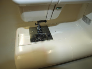 Pop the storage tray back on. Rethread the machine, power up and  test your stitches and tension. Then back to work!